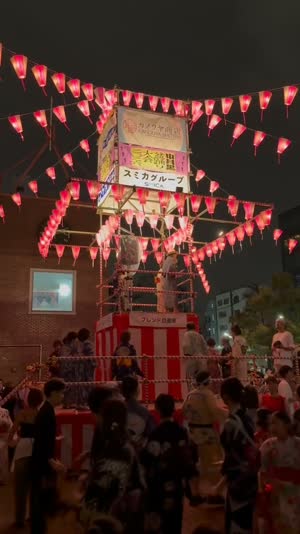 Low angle of feet in geta sandals and yukata hems stepping from the darkness toward a glowing circle of dancers, no barriers or seats anywhere, inviting lantern light