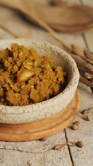 Mound of golden amber rice miso paste in a rustic ceramic bowl, visible grain texture, angled close-up, clean natural daylight