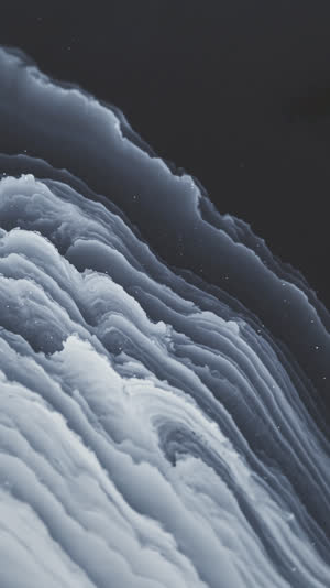 Contemplative macro along a hamon's billowing wave pattern, like clouds over night water, meditative beauty in steel, soft directional light