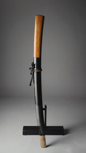 Japanese sword in a plain wooden shirasaya scabbard displayed on a lacquered stand, museum still-life, soft focused lighting, dignified and calm
