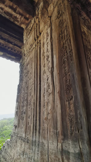 Extreme close-up of an ancient wooden temple pillar surface, deep grain and centuries of weathering, soft directional light, photorealistic documentary photograph, natural soft…